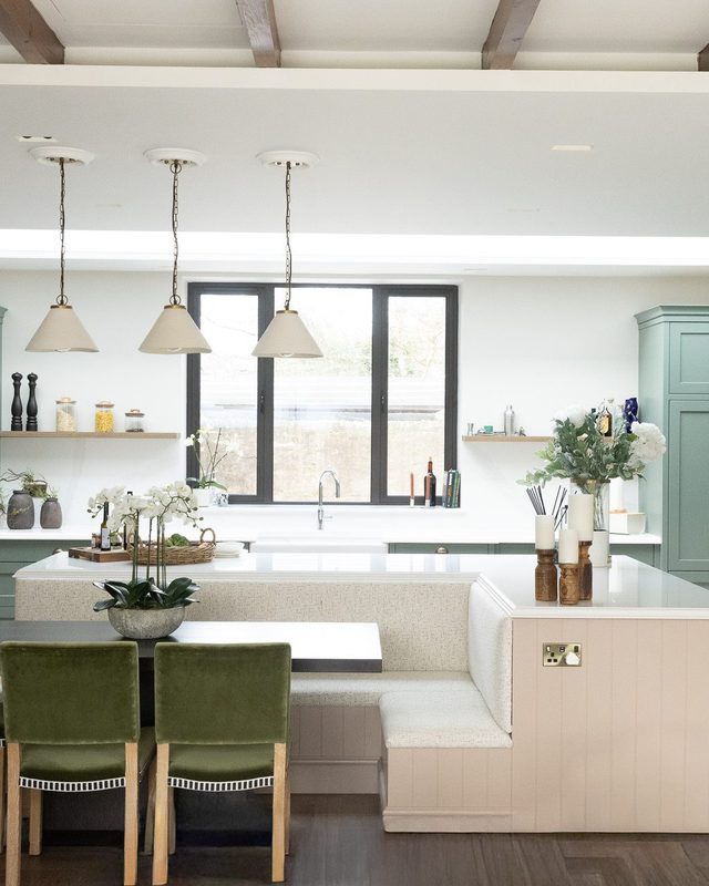 Elmfield Road kitchen with three pendants, a banquette and green velvet stools