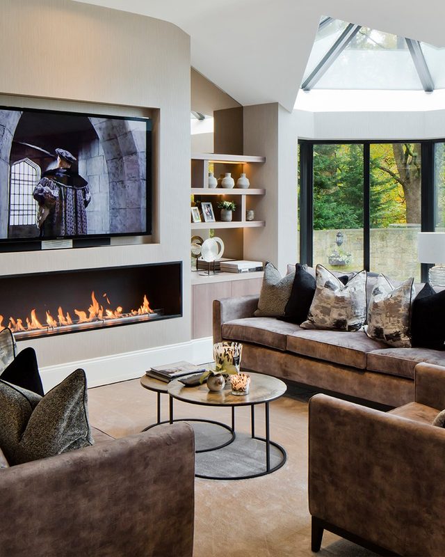 Northumberland living room with a long fire, a lit niche and leather sofas