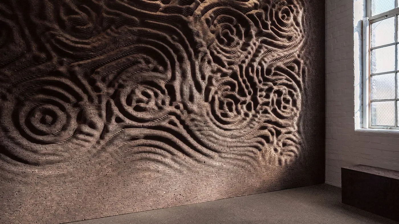 GenCork lets an algorithm cut the relief into a black cork wall, image via Dezeen