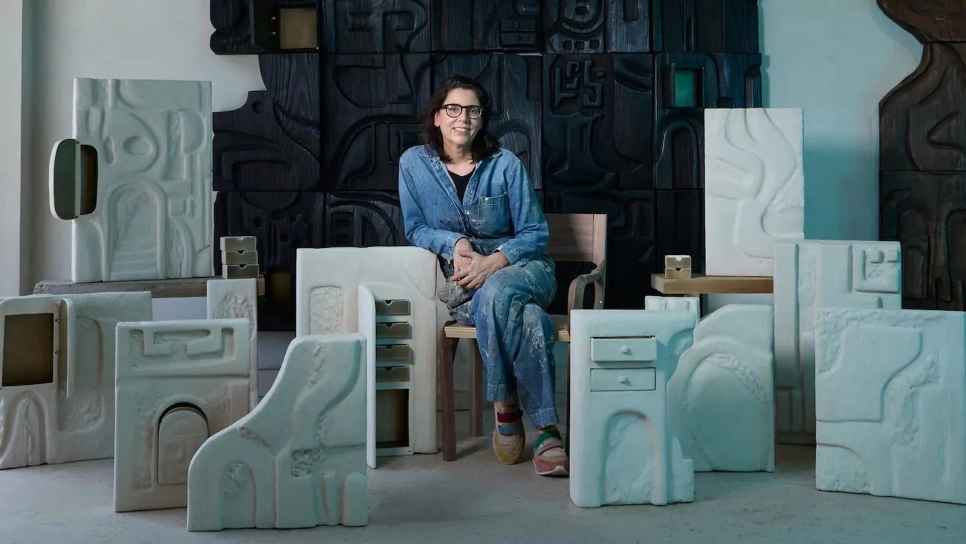 The LA sculptor who carves the door, the column and the fireplace on site, image via Business of Home