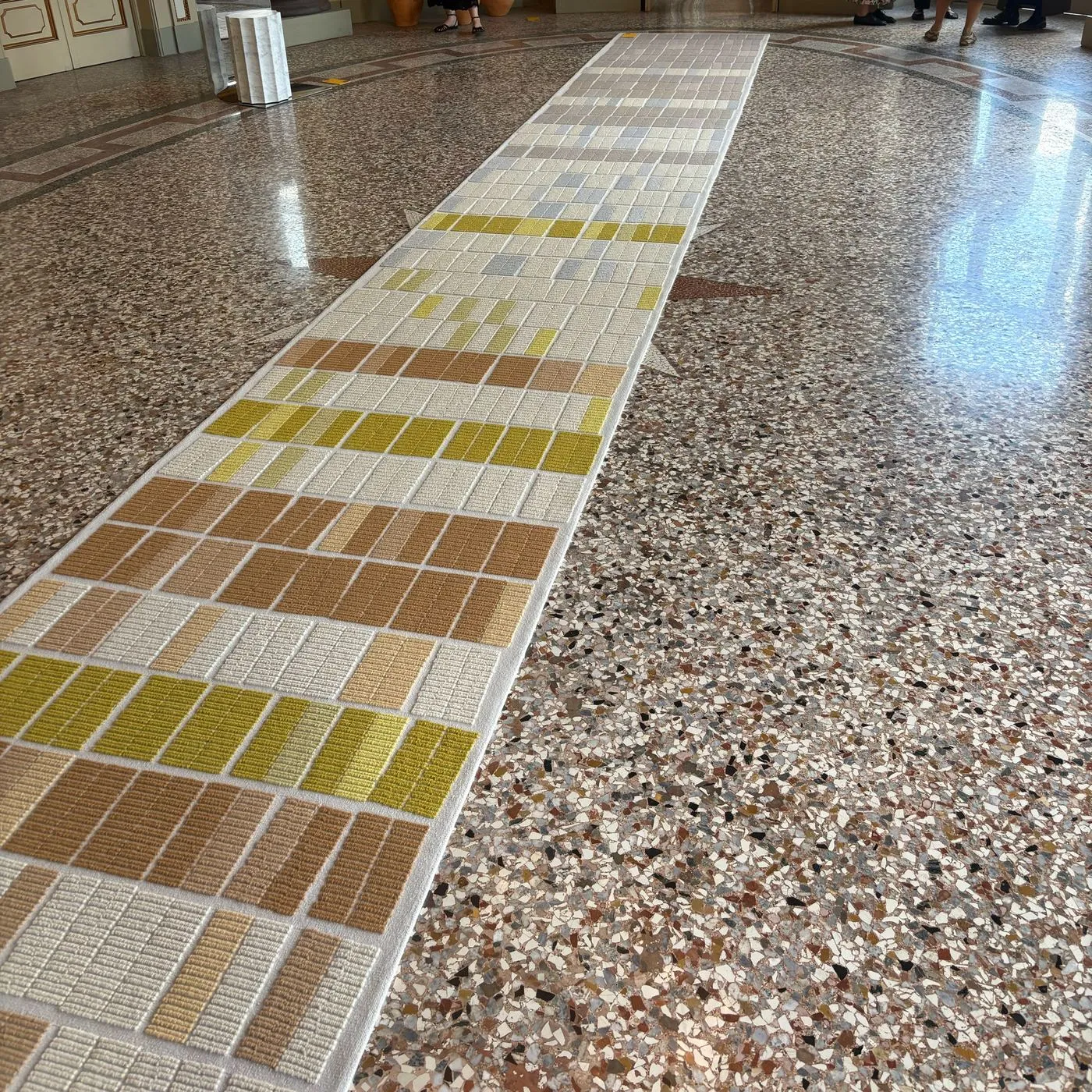 The Happy Few weave a ten-metre street into a rug that changes season down its length, image via Dezeen
